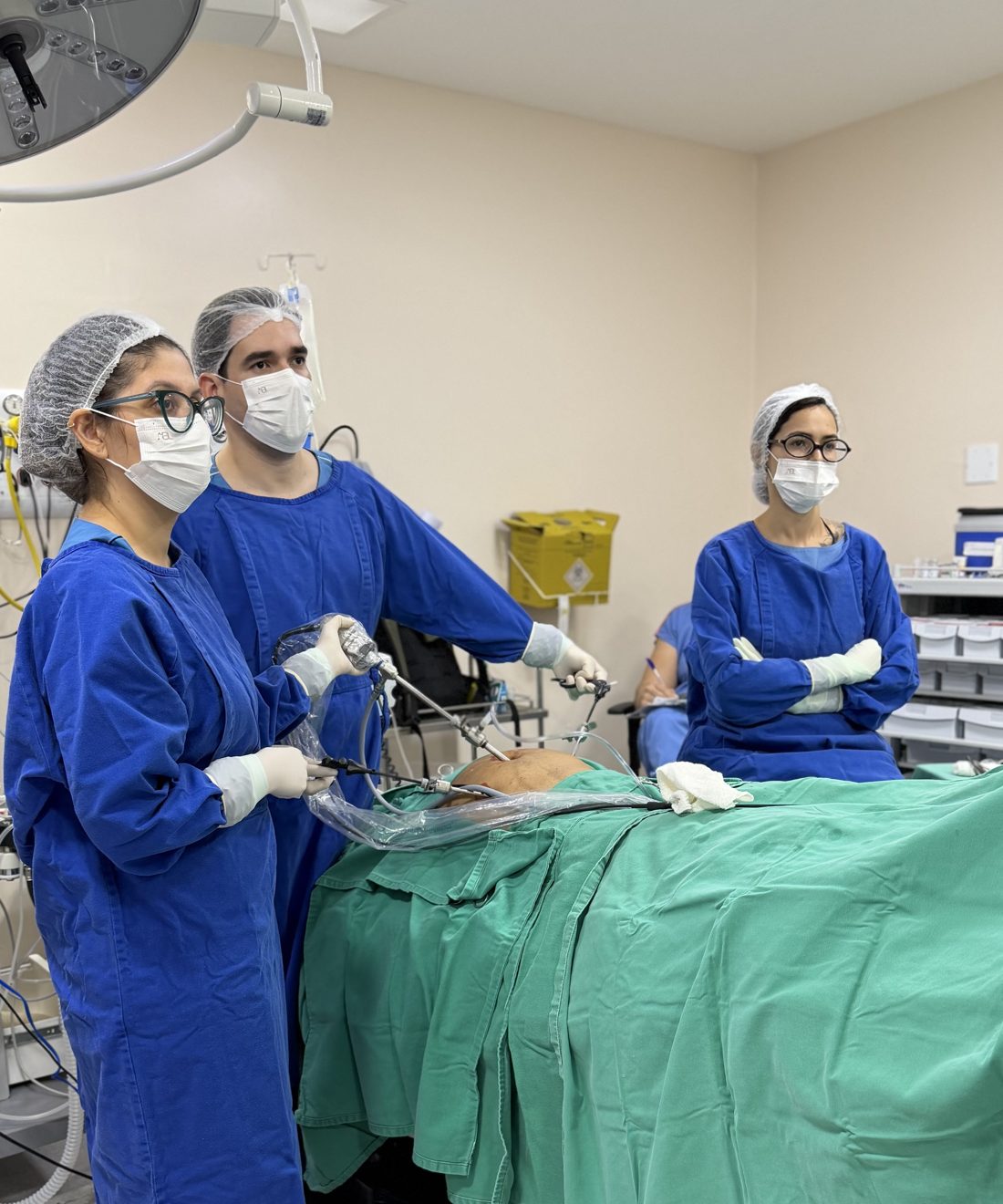 Equipe da Cirurgia Já durante cirurgia por vídeo, com o paciente coberto por campo cirúrgico